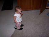Mary standing in mommy's shoes.  Picture shot from above.