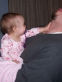 Mary pushing on daddy's throat making him bend his head backwards.