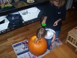 Mary scooping out the pumpkin.