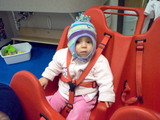 Mary sitting in the school buggy in her snow cap with ear flaps.