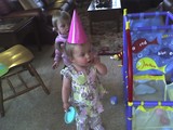 Mary standing in a party hat.