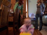 Mary in the foreground of the picture but just as a blur because she is moving so fast.  You can see mommy and Aunt Corinne laughing to each other in the background.