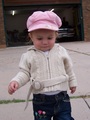 Mary in her pink waif hat and tan knitted sweater.