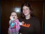 Aunt Corinne holding Mary while Mary holds the water bottle.