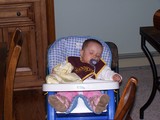 Mary slumped over, asleep, in her high-chair.