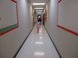 Mary in her Carebear costume walking down the hall alone.