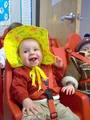 Mary in the daycare buggy in a floppy yellow hat.